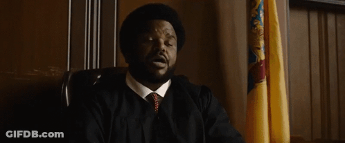 Man In Suit And Tie Saying I'll Allow With Flag GIF