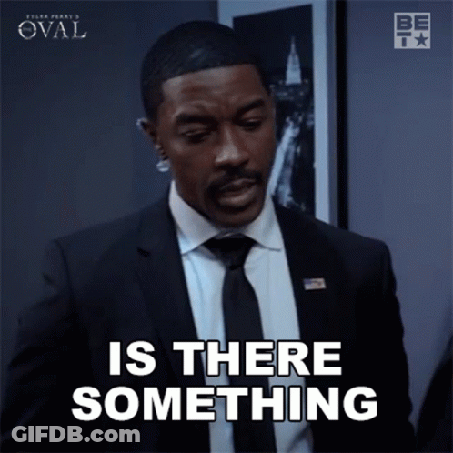 Man In Suit And Tie Saying Is There Something GIF