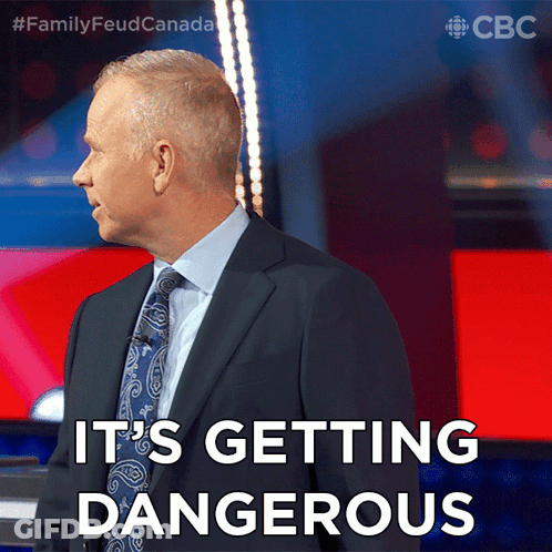 Man In Suit And Tie Saying Its Getting Dangerous GIF