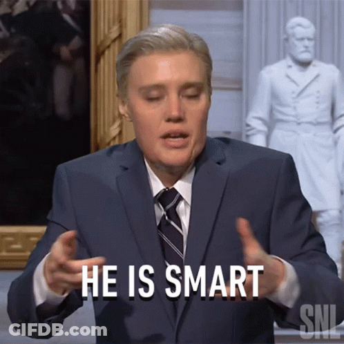 Man In Suit And Tie Saying Smart Before Statue GIF