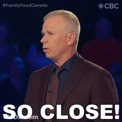 Man In Suit And Tie Saying So Close GIF