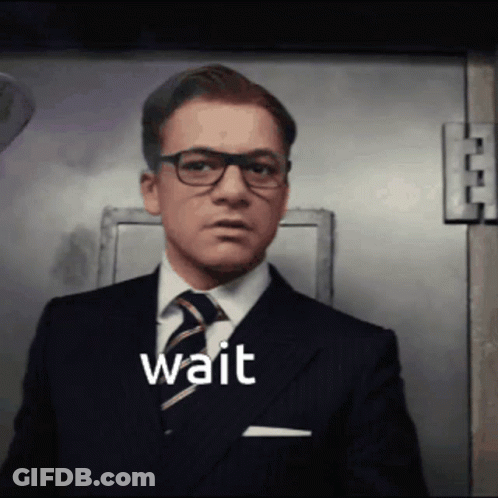 Man In Suit And Tie Saying Wait GIF