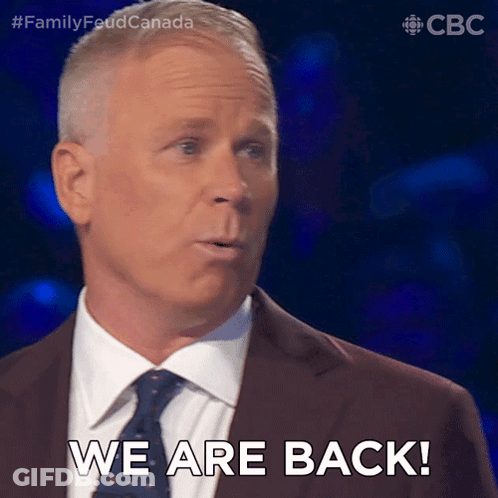 Man In Suit And Tie Saying We Are Back GIF