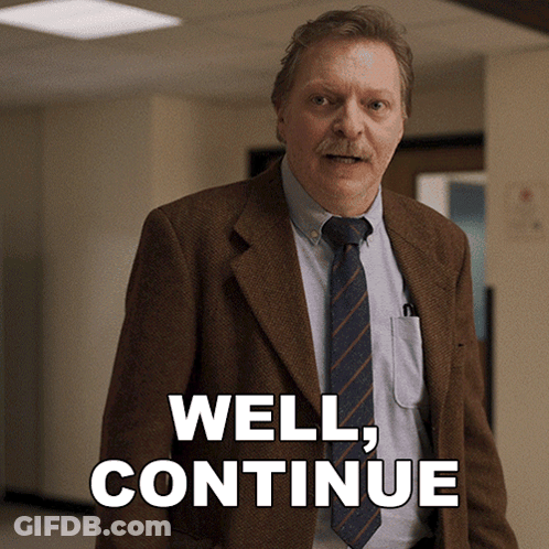 Man In Suit And Tie Saying Well Continue GIF