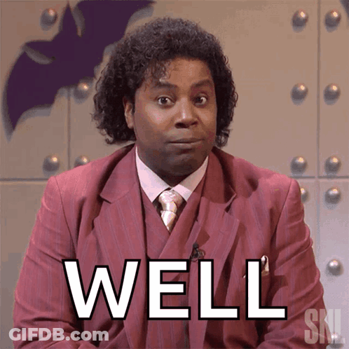 Man In Suit And Tie Saying Well GIF