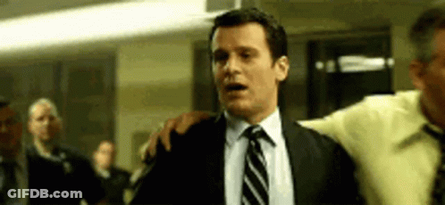 Man In Suit And Tie Saying Whaaaaat Into Microphone GIF