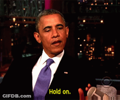 Man In Suit And Tie Saying Yellow Hold On GIF