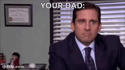 Man In Suit And Tie Saying Your Dad At Desk GIF