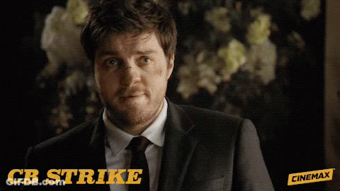 Man In Suit And Tie Says CB Strike GIF