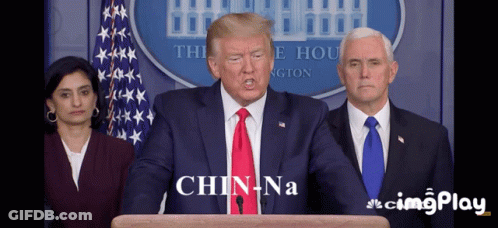 Man In Suit And Tie Says Chin Na GIF