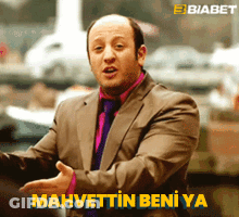 Man In Suit And Tie Says Mahvettin Beni Ya In Yellow Letters GIF
