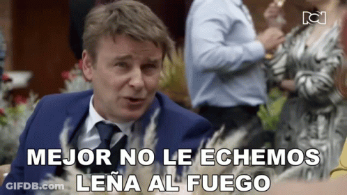 Man In Suit And Tie Says Mejor No Le Echamos Lena Al Fuego GIF