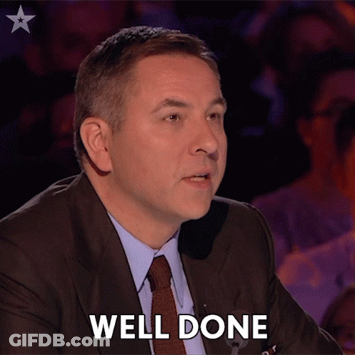 Man In Suit And Tie Says Well Done In Front Of Crowd GIF