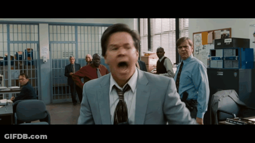 Man In Suit And Tie Screaming In Police Office GIF