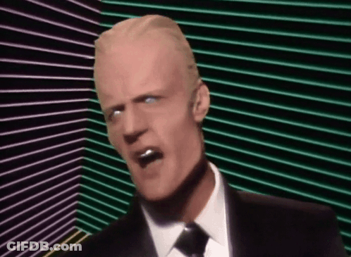 Man In Suit And Tie Screaming Into Microphone With Sunglasses GIF
