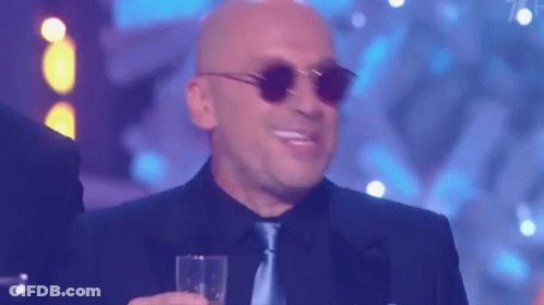 Man In Suit And Tie Screaming With Green Hard Hat GIF