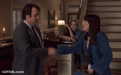 Man In Suit And Tie Shakes Hands With Woman GIF