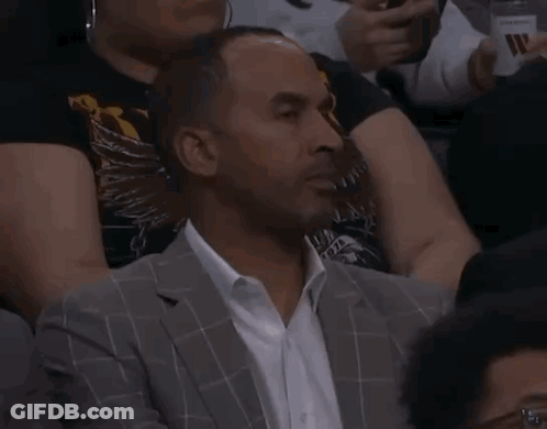 Man In Suit And Tie Shaking Hands With Basketball Player In White Shirt GIF
