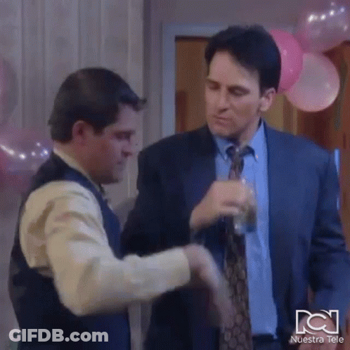 Man In Suit And Tie Shaking Hands With Man In Vest GIF