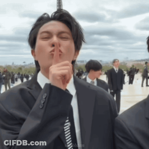 Man In Suit And Tie Shushing GIF
