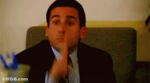 Man In Suit And Tie Shushing GIF