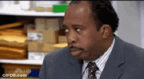 Man In Suit And Tie Sitting GIF