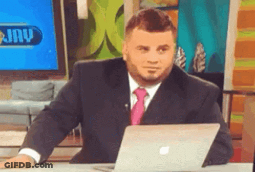 Man In Suit And Tie Sitting At Apple Laptop GIF