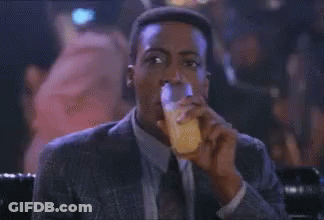Man In Suit And Tie Sitting At Bar GIF