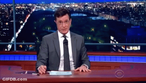 Man In Suit And Tie Sitting At Desk GIF