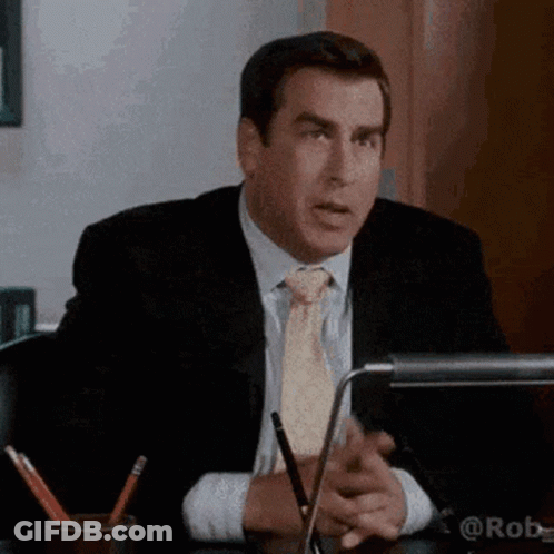 Man In Suit And Tie Sitting At Desk GIF