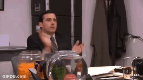 Man In Suit And Tie Sitting At Desk GIF