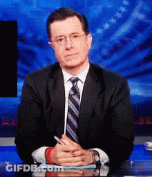 Man In Suit And Tie Sitting At Desk GIF
