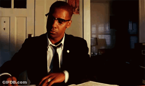 Man In Suit And Tie Sitting At Desk GIF