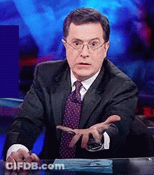 Man In Suit And Tie Sitting At Desk GIF