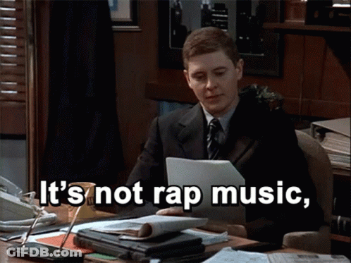 Man In Suit And Tie Sitting At Desk GIF