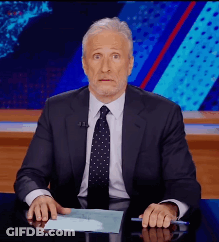 Man In Suit And Tie Sitting At Desk With Hands On Paper GIF