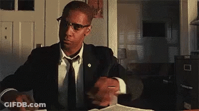 Man In Suit And Tie Sitting At Desk With Pencil GIF
