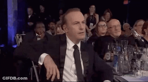 Man In Suit And Tie Sitting At Dinner Table GIF