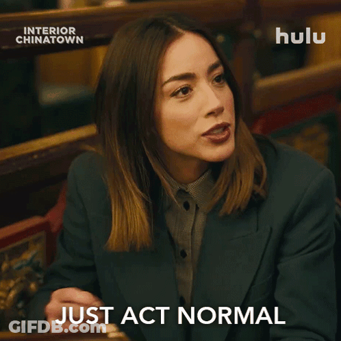 Man In Suit And Tie Sitting At Hulu Ad GIF