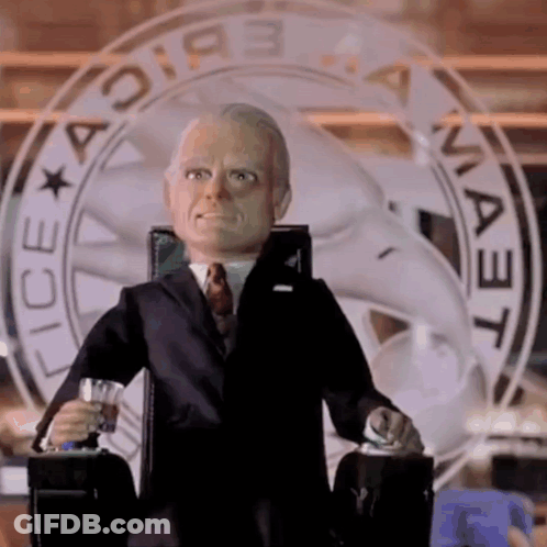 Man In Suit And Tie Sitting At Ice Sign GIF