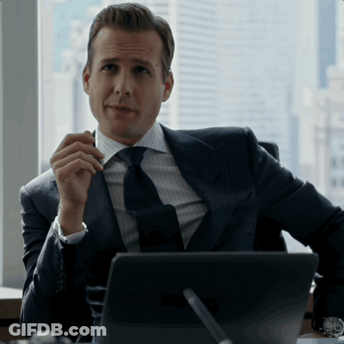 Man In Suit And Tie Sitting At Laptop GIF