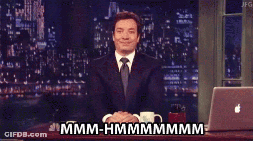 Man In Suit And Tie Sitting At Laptop Saying Hmm Hmmmm GIF