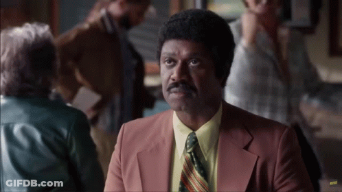 Man In Suit And Tie Sitting At Restaurant Table GIF
