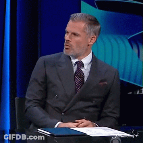 Man In Suit And Tie Sitting At Table GIF