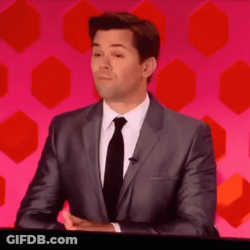Man In Suit And Tie Sitting At Table GIF
