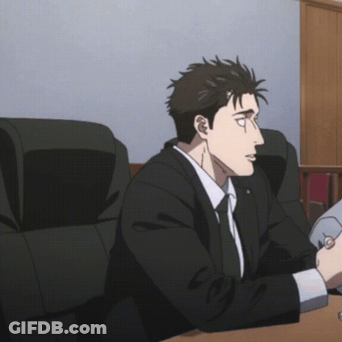 Man In Suit And Tie Sitting At Table GIF