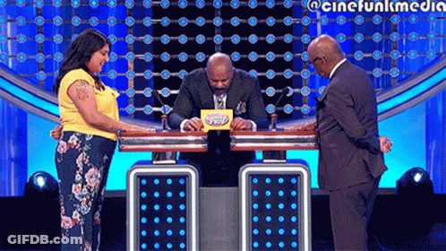 Man In Suit And Tie Sitting At Table With Woman And Two Men GIF