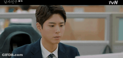 Man In Suit And Tie Sitting At TVN Screen GIF