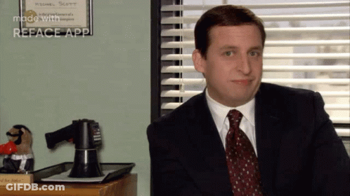 Man In Suit And Tie Sitting At Window GIF