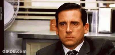 Man In Suit And Tie Sitting By Microwave GIF